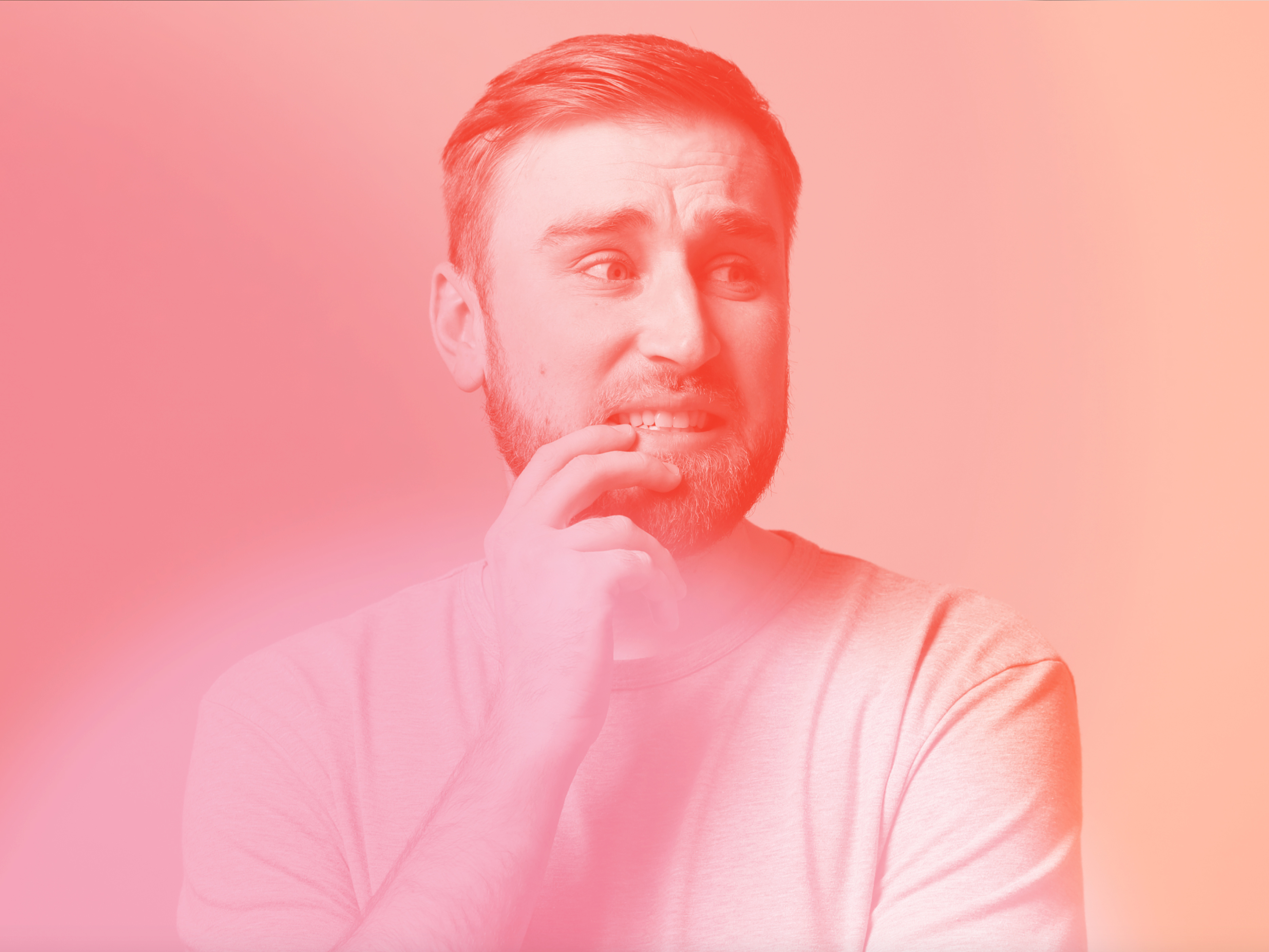 a person with a beard and a hand on his chin