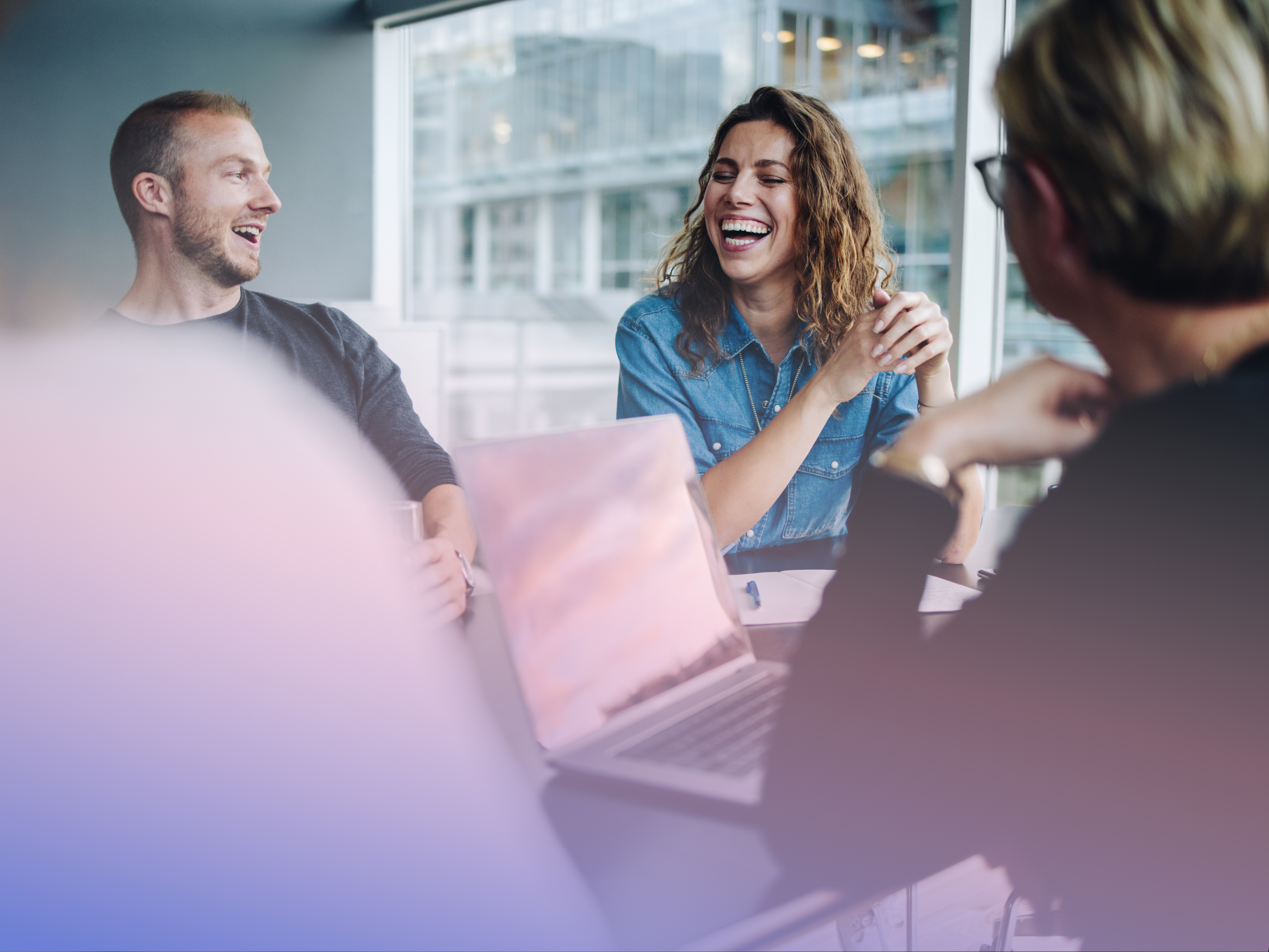 a group of people laughing at a table