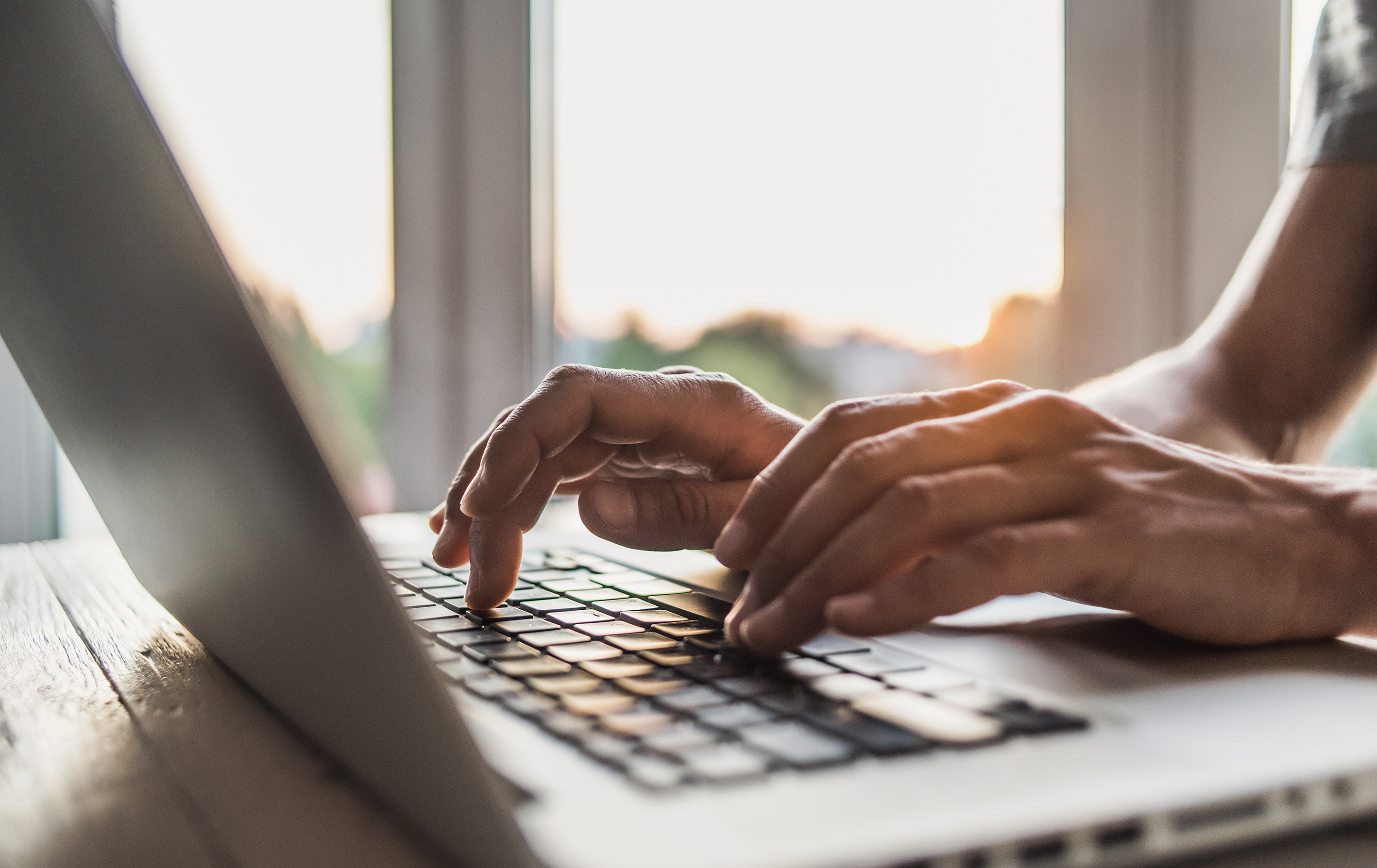 a person typing on a laptop