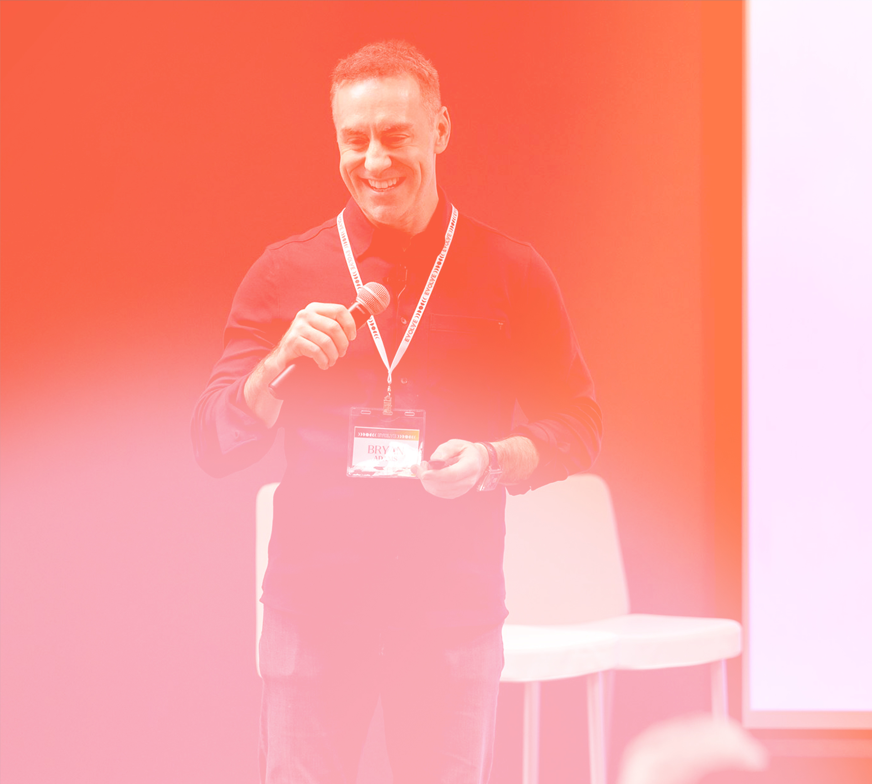 a person holding a microphone and smiling