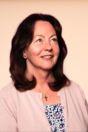 a person with brown hair and a cross necklace