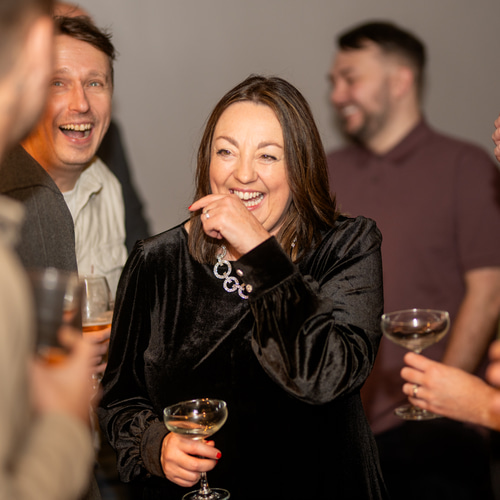 a person laughing with a group of people around