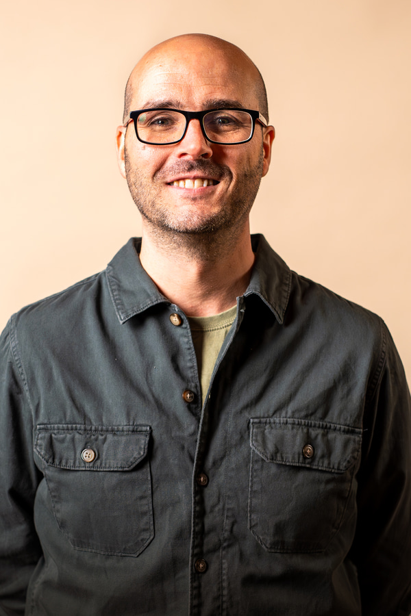 a person wearing glasses and a button up shirt