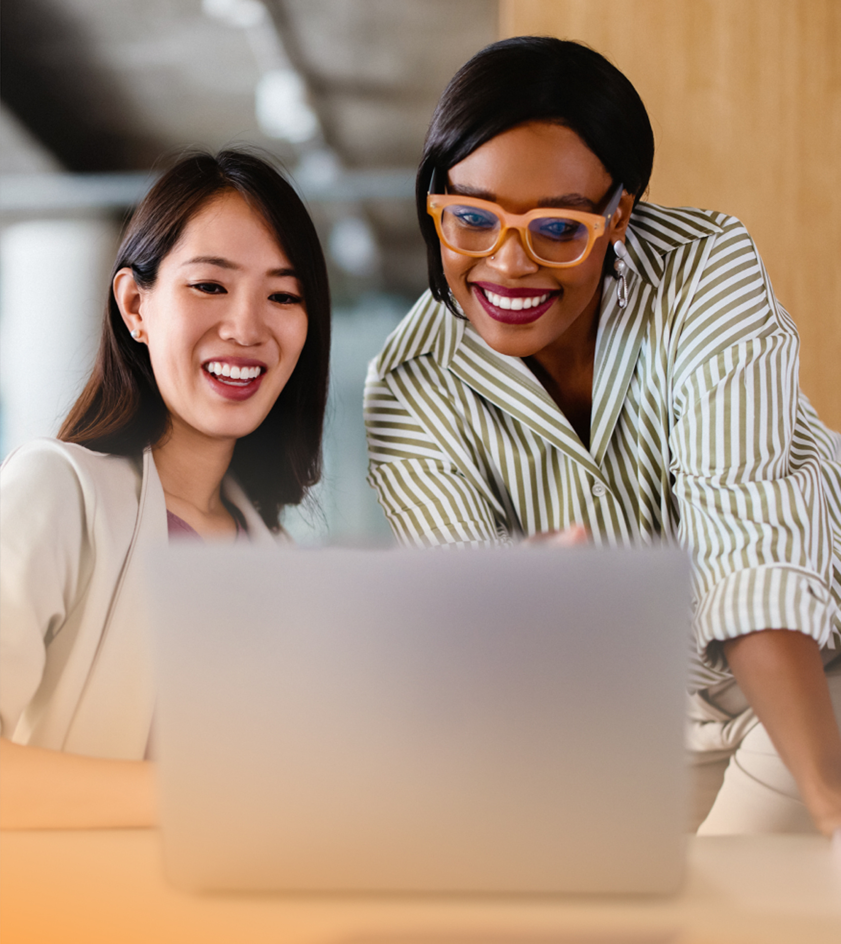 a group of women looking at a laptop