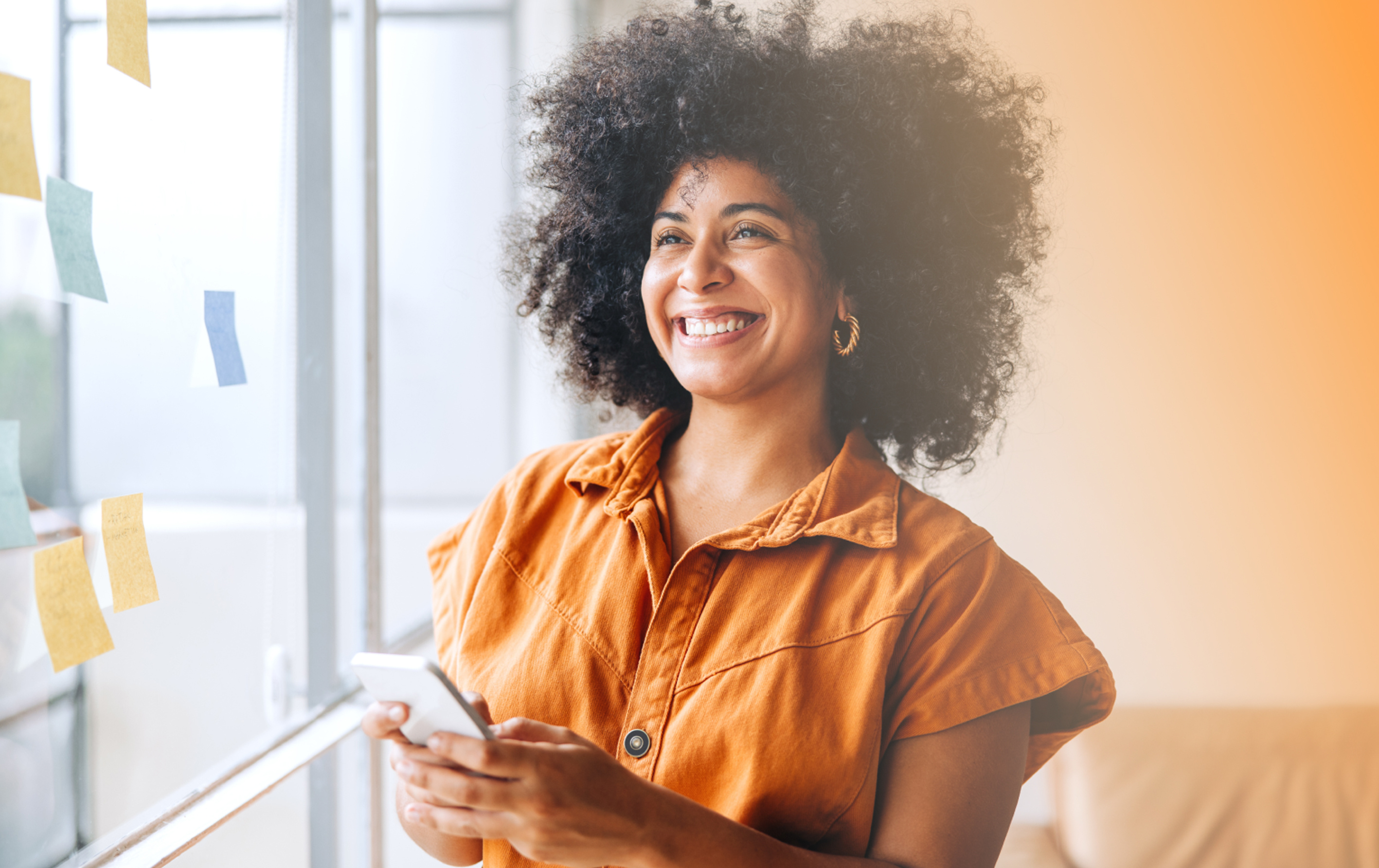 a person smiling while holding a phone