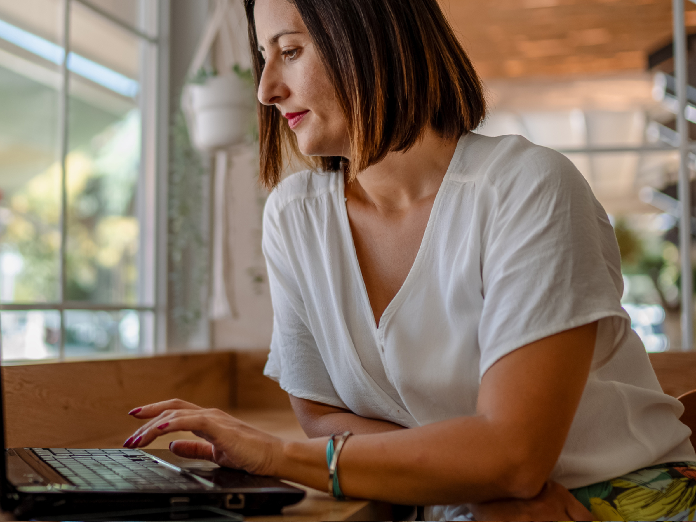 a person sitting at a desk with a laptop