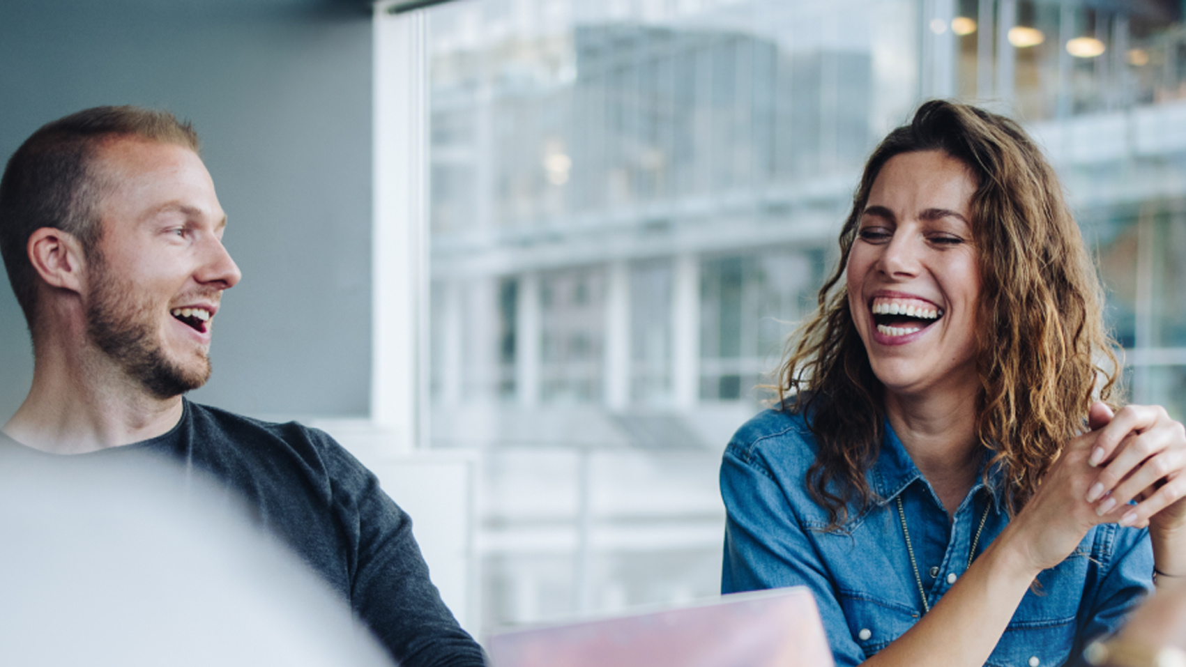 a person and person laughing at a table
